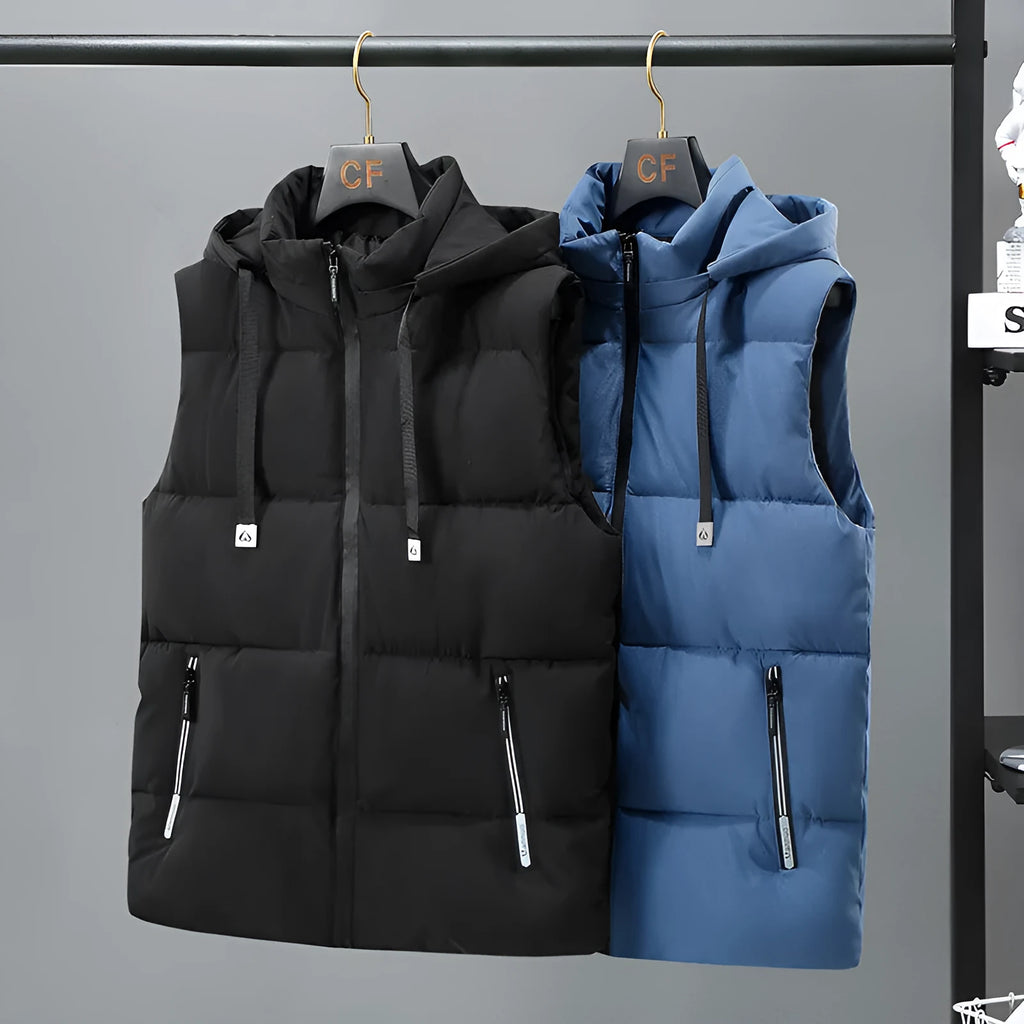 Men's solid blue fleece-lined vest with a detachable hood on a hanger.