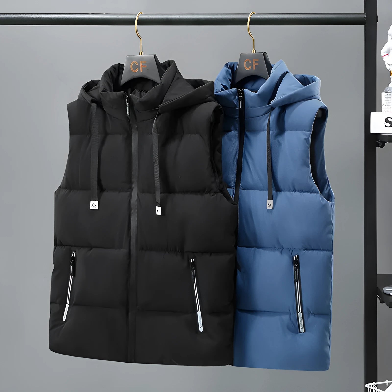 Men's solid blue fleece-lined vest with a detachable hood on a hanger.
