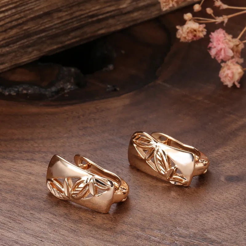Hollow-carved floral copper earrings with smooth surface and U-shaped design in H0147 colour