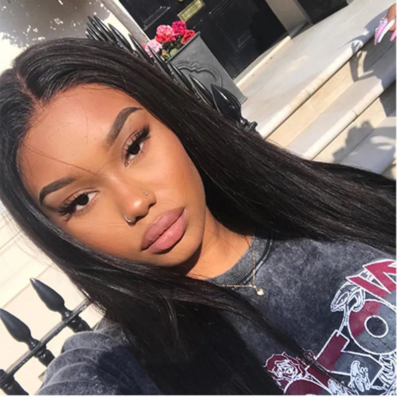 Long straight black synthetic wig with centre-parted fringe on a model