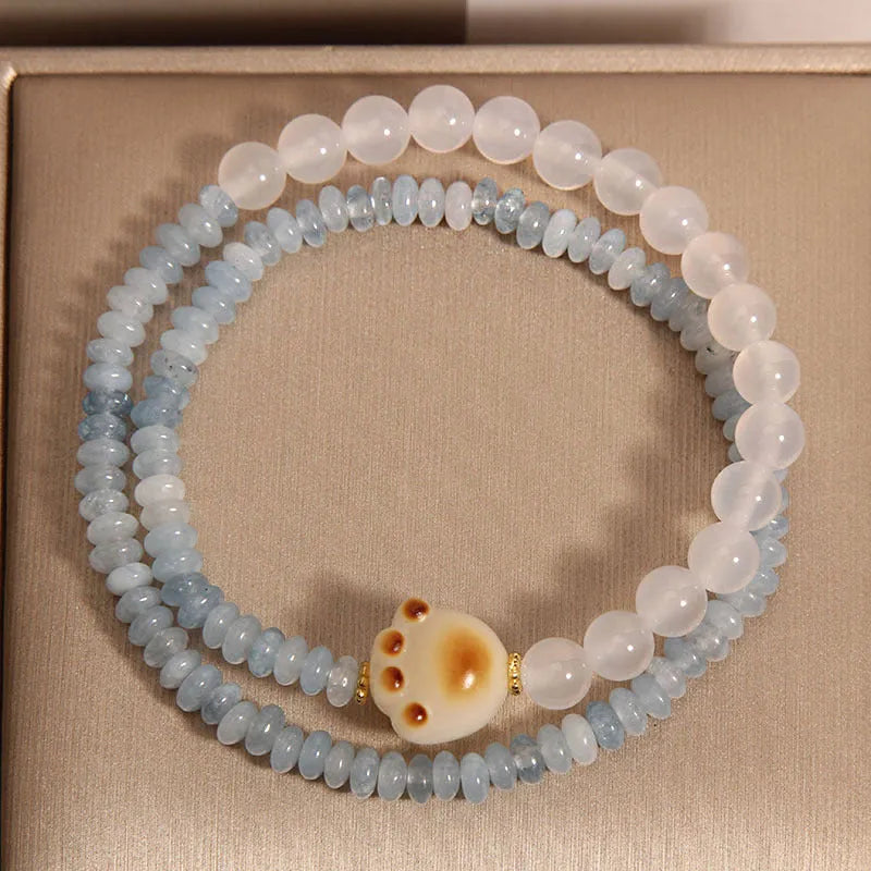 Women's crystal bracelet with aquamarine abacus beads, white agate, and cat's paw accents in double ring design