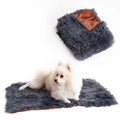 Grey velvet and plush pet blanket laid on a sofa, showing its soft texture and size.