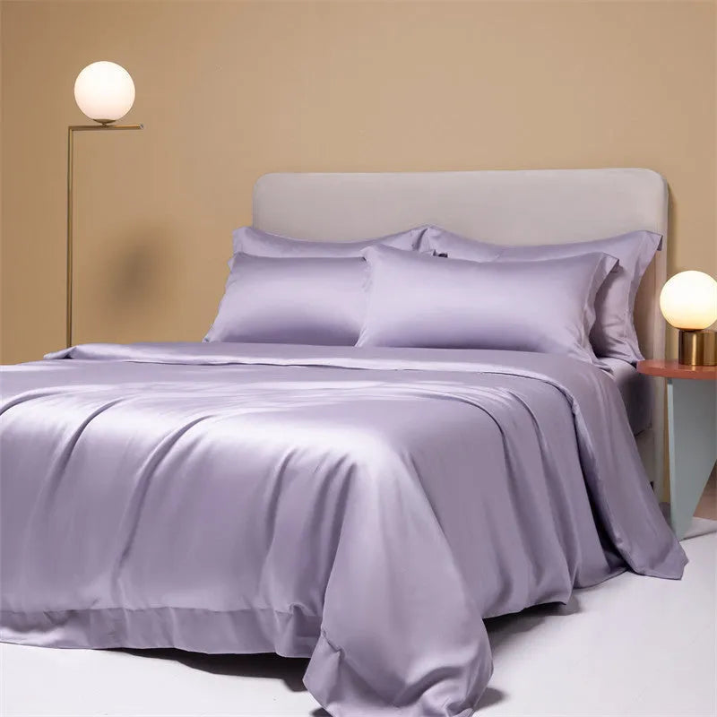 Aurora Blue 200 thread count Tencel duvet cover, fitted sheet, and pillowcases laid on a modern bed.