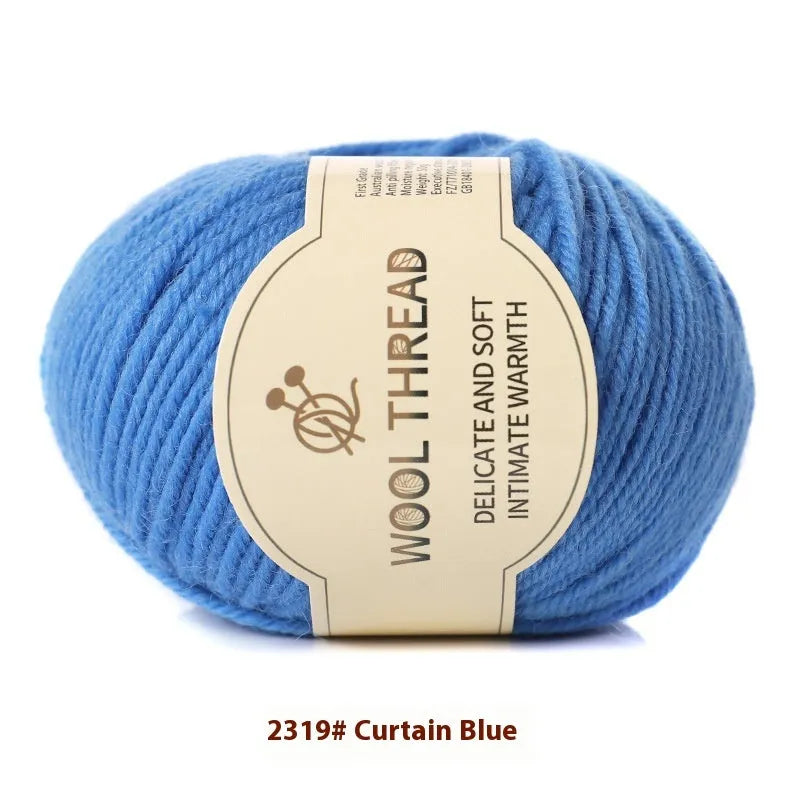 One roll of beige domestic wool hand-knitting yarn for size 10 needles next to knitting needles.