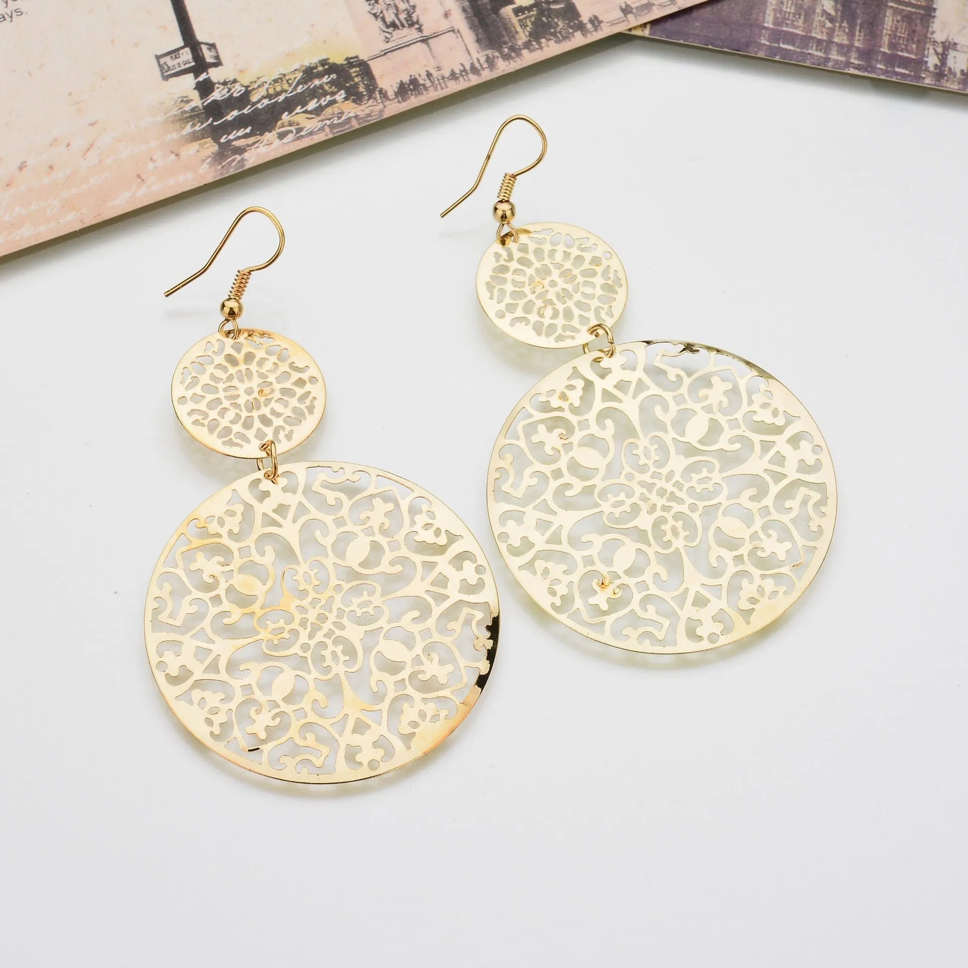 Women's gold round hollow dangle earrings made from zinc alloy, 4.5 by 8 cm, one pair