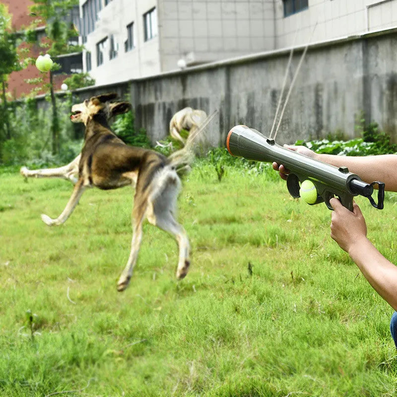 Black ABS plastic tennis ball launcher for dogs with one tennis ball, showing its long 65.5 cm design.