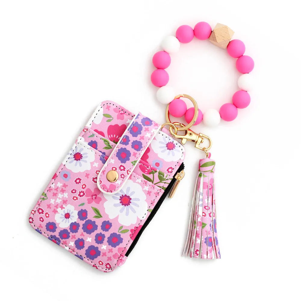 Women's floral print leather card bag in light pink, compact size, on plain background