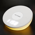 White wireless charging pad with LED clock display showing time, three control buttons, and Qi charging surface for smartphones
