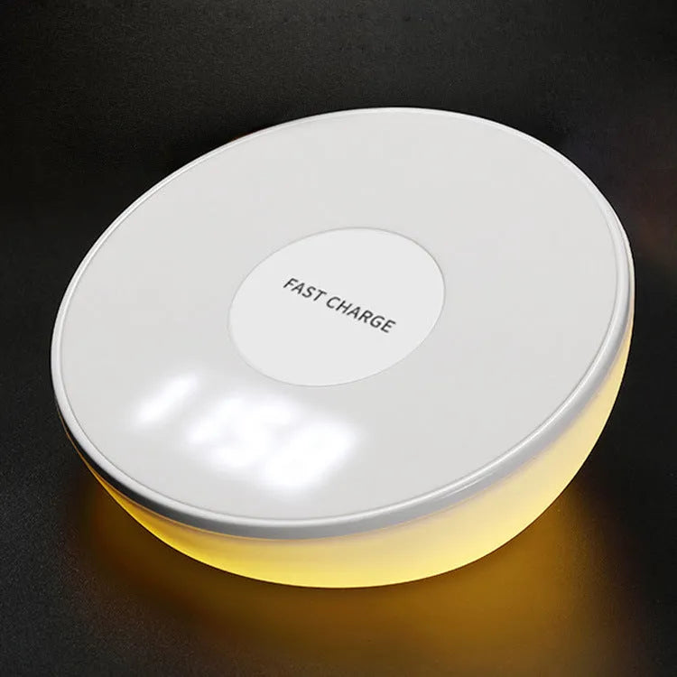 White wireless charging pad with LED clock display showing time, three control buttons, and Qi charging surface for smartphones