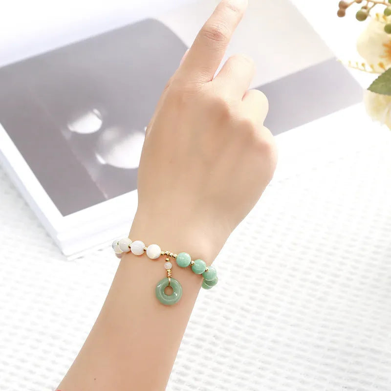 Women's Burma jade bracelet with copper horseshoe screw safety clasp showing 8mm round beads