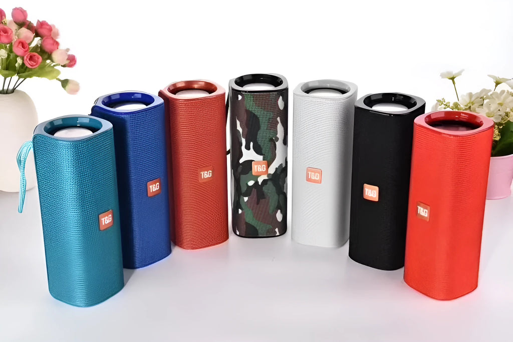 Cloth wireless Bluetooth speaker in multiple colours showing front grill and control buttons.
