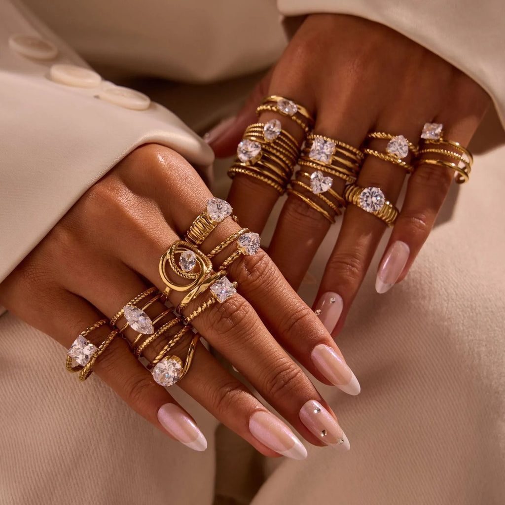 Gold electroplated stainless steel ring with zircon accents in open mouth geometry design
