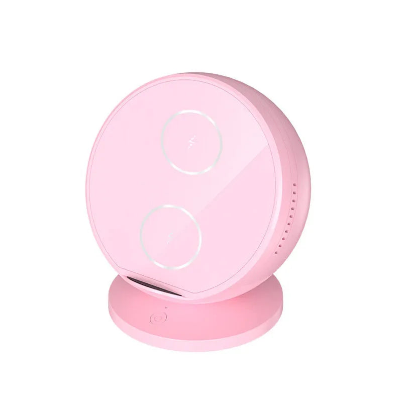 Black multifunctional wireless phone charging holder with integrated Bluetooth speaker on a desk.