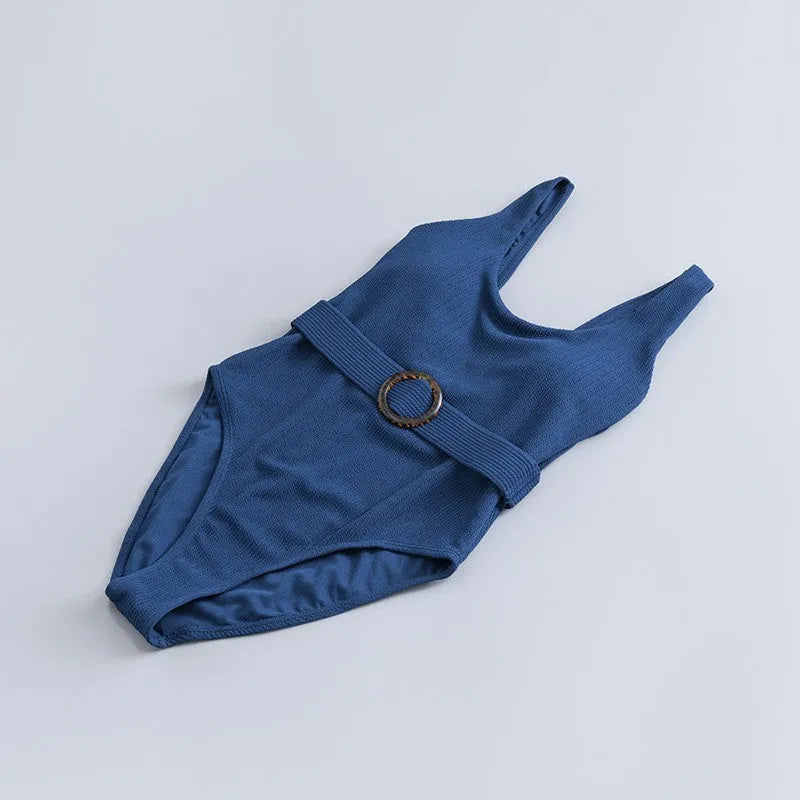Navy blue women's slim-fitting one-piece triangle swimsuit on a mannequin.