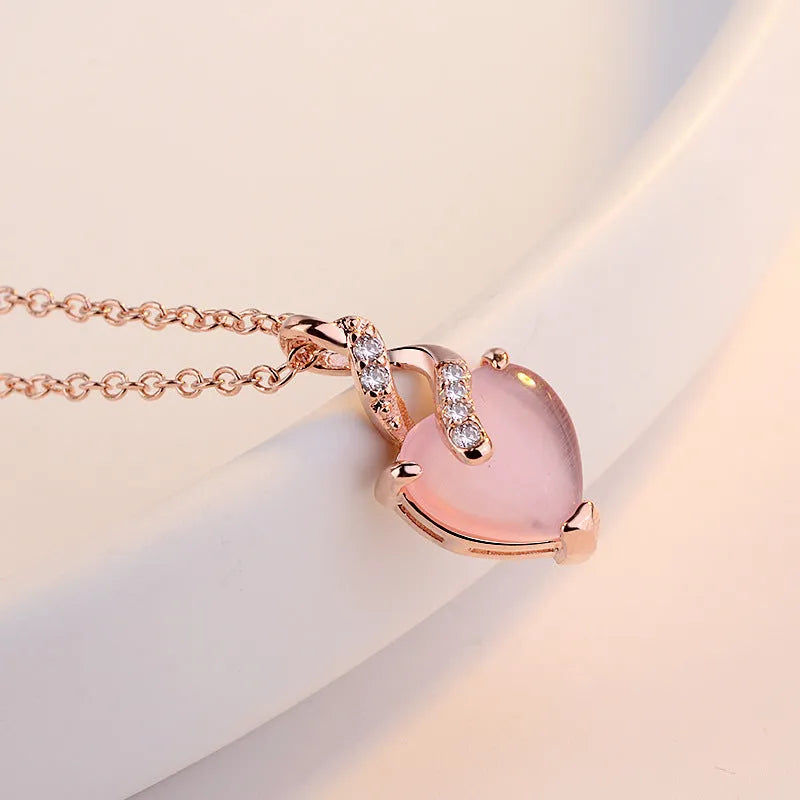 Heart-shaped pink crystal pendant necklace with rose gold cross chain for women