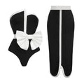 Black and white colour-block women's one-piece swimsuit with an asymmetrical bow on the tube top.