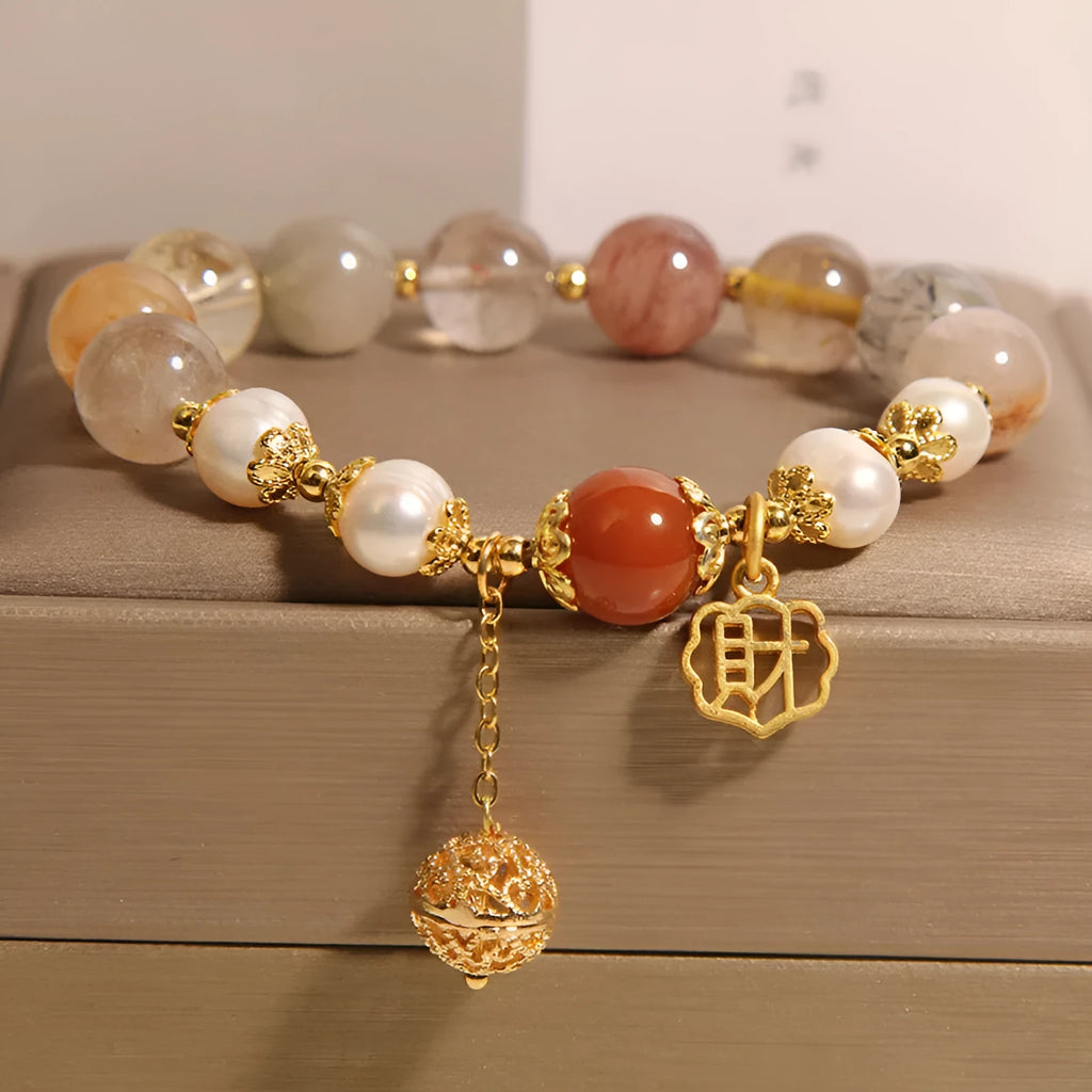 Women's Japanese-style crystal bracelet with pearls and Chinese 'Cai' character charm.