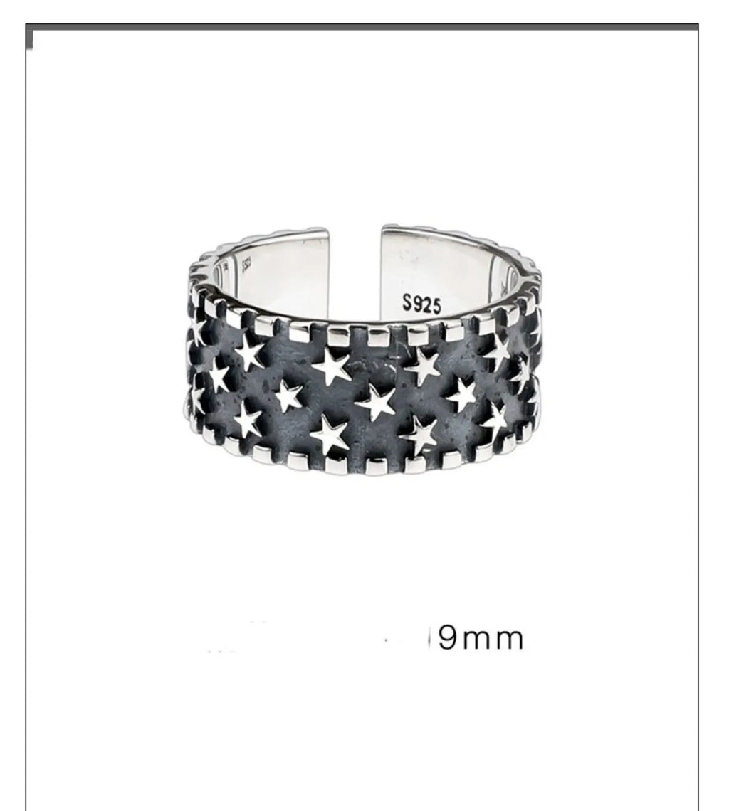 Adjustable sterling silver ring with a geometric pattern of five-pointed stars on the band.