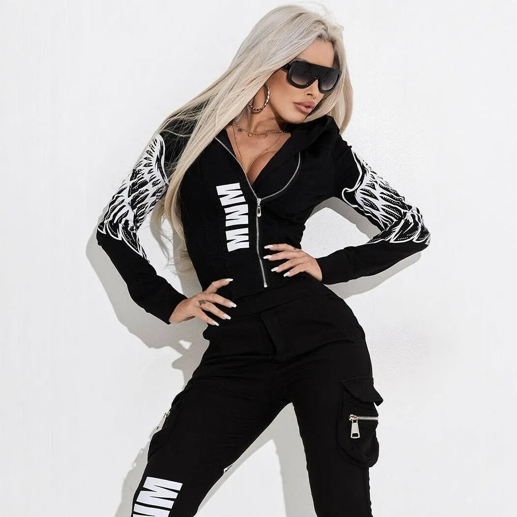 Black women's zip-up hoodie with wings print and matching casual trousers laid flat.