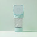 Green 3-in-1 portable pet water bottle with bowl, food container, and bag dispenser attached to a strap.