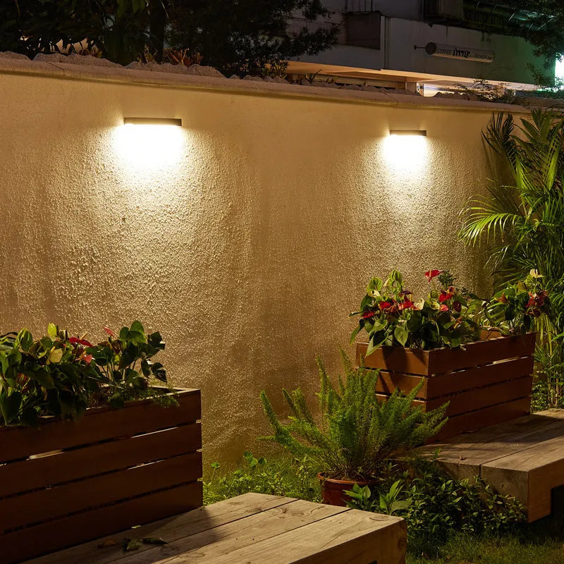 Solar-powered outdoor wall lamp with black ABS plastic shell and IP65 waterproof rating for garden lighting