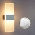 Modern acrylic LED wall lamp in black gold or silver with dual warm white light colours