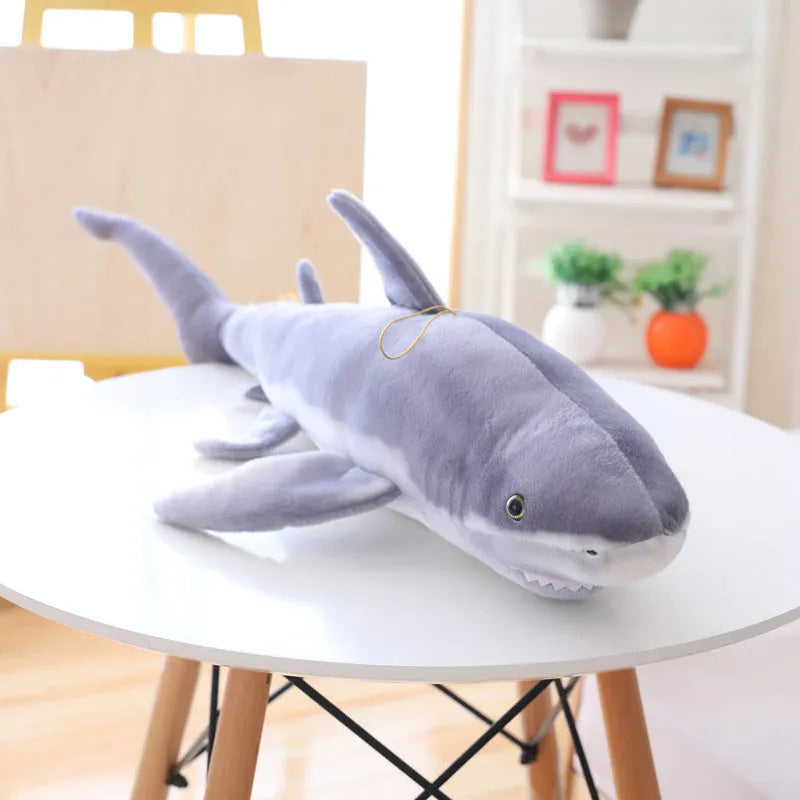 Lifelike soft shark plush toy in shark colour, available in 60cm, 100cm, and 140cm heights, net pocket packaging
