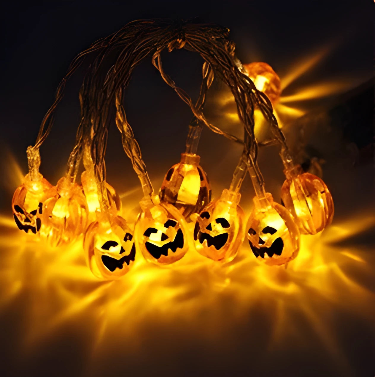 Halloween LED string lights with pumpkin, bat, and ghost decorations hanging on a wall