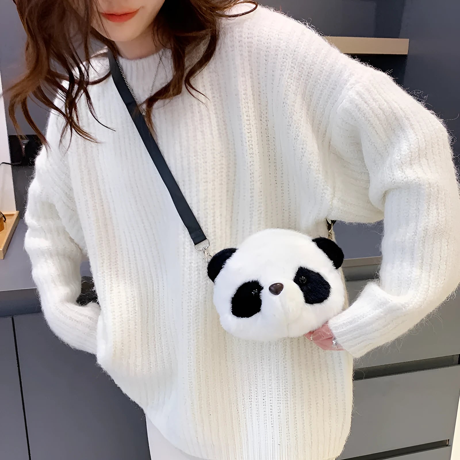 Soft plush cylindrical crossbody bag in panda head design with a sandwich pocket.