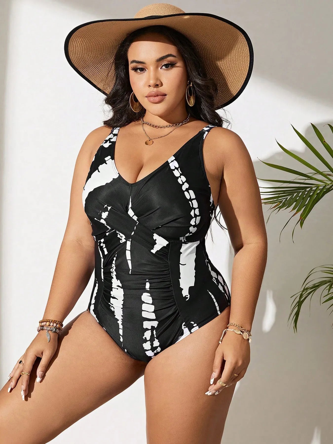 Black colour matching one-piece swimsuit with conservative cut and sleeveless design on mannequin