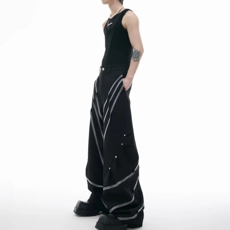 Men's black polyester trousers with metal rivet stripe and front pleats on a white background.