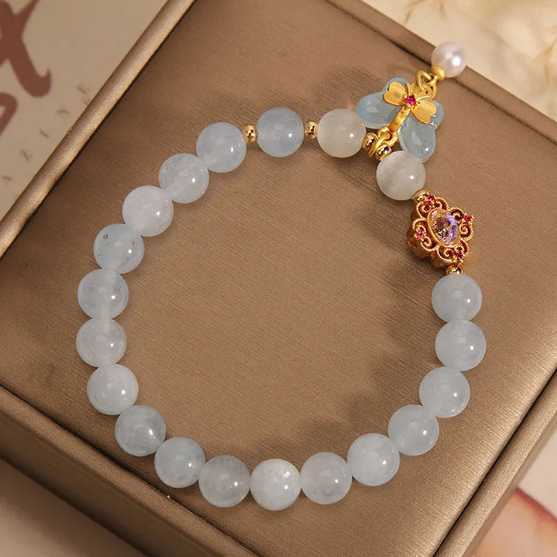 Women's crystal bracelet with aquamarine butterfly pendant and rhinestone details