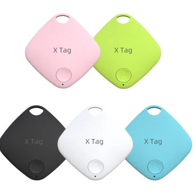 Small black Bluetooth key finder tracker on a keyring next to a smartphone showing location app.