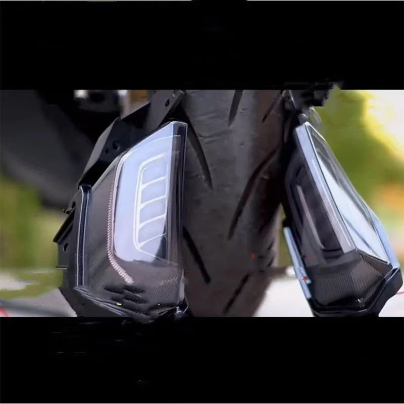 Pair of white and yellow LED turn signal lights mounted on a Yamaha NMAX155 scooter's steering column