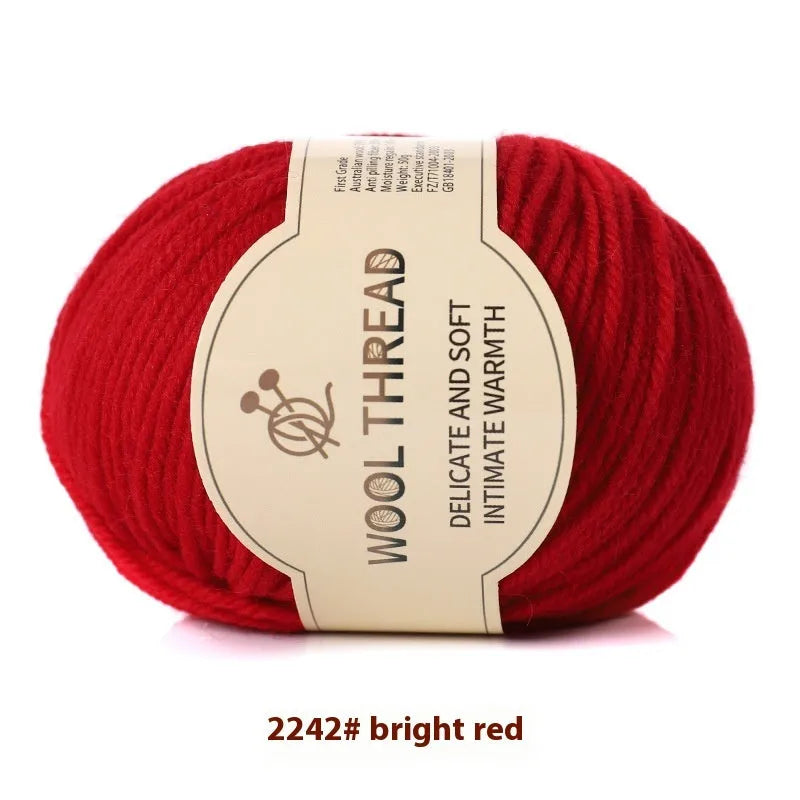 One roll of beige domestic wool hand-knitting yarn for size 10 needles next to knitting needles.