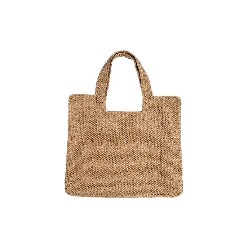 Woven straw tote bag with double shoulder straps in a horizontal square shape, shown in a neutral colour.