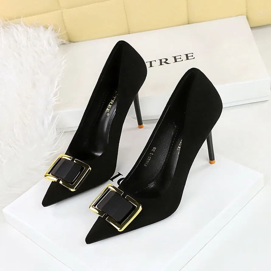 Black suede women's high heels with a stiletto heel and pointed toe on a white background.
