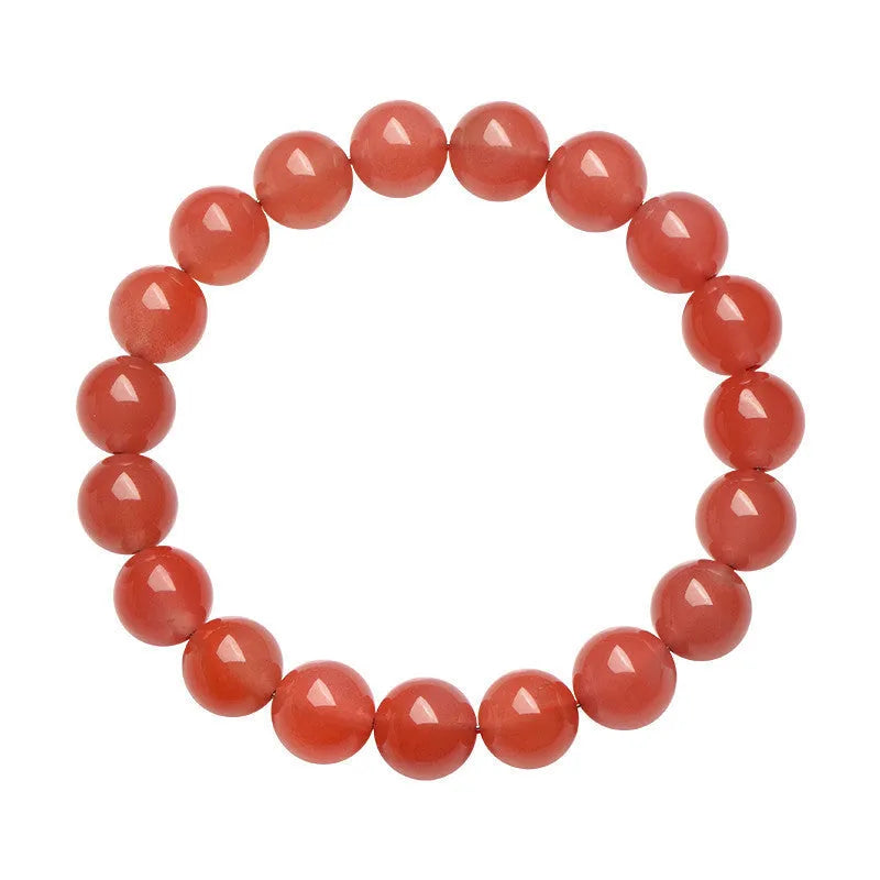 Natural cherry red agate bracelet with hand-polished beads on a wrist, showing colour variation and secure clasp.