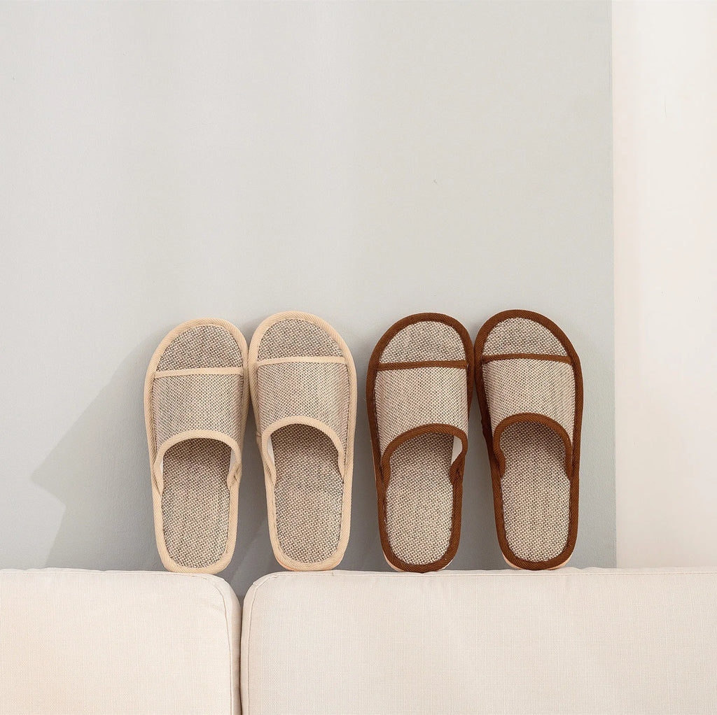 Women's open-toe linen slippers in a light brown colour showing the breathable fabric and thickened sole.