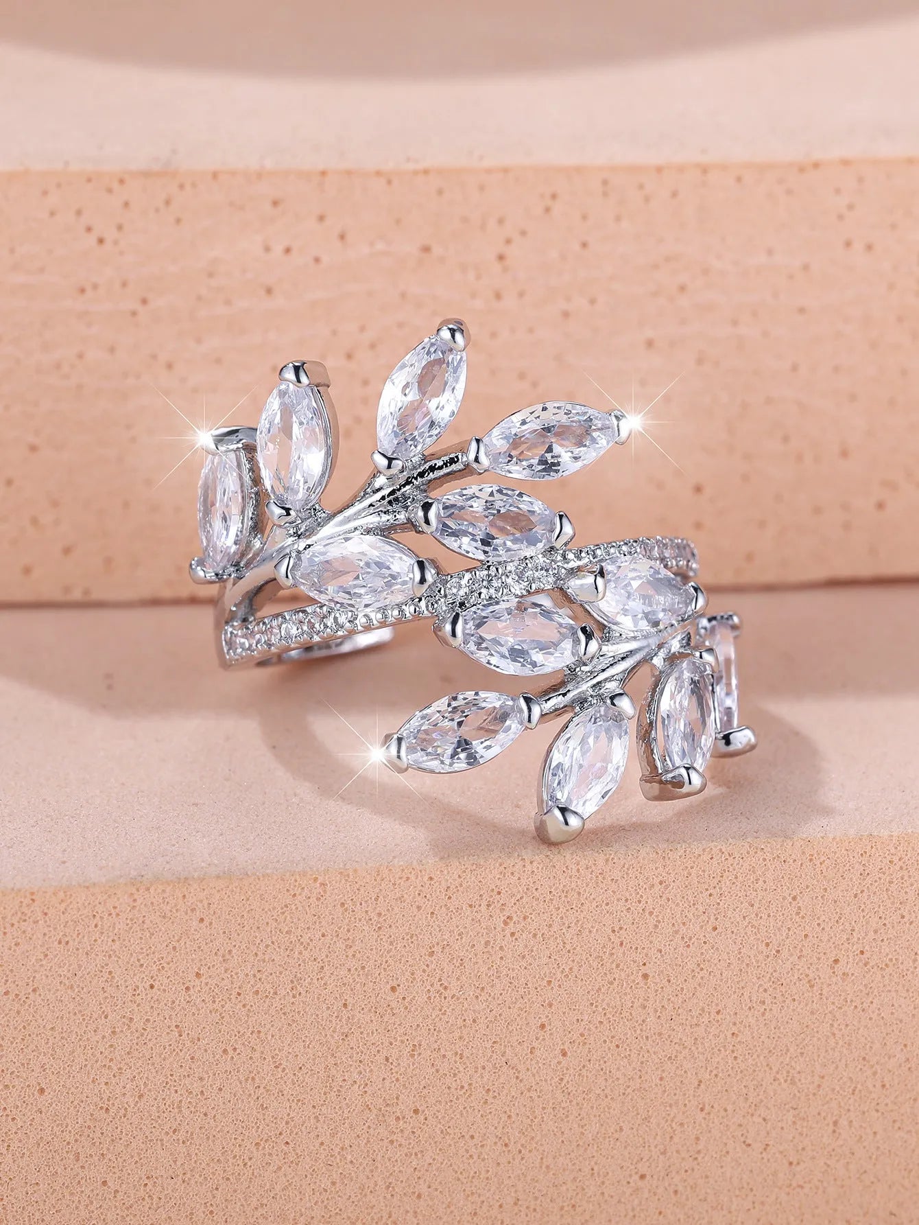 Adjustable copper leaf-shaped ring with a central horse eye zircon stone, shown in a rose gold finish.