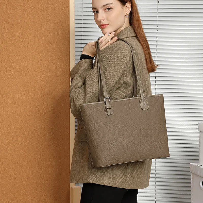 Genuine leather women's tote bag with multiple internal compartments showing document and phone pockets