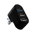 Black and white USB 3.0 four-port rotary splitter hub on a desk next to a laptop