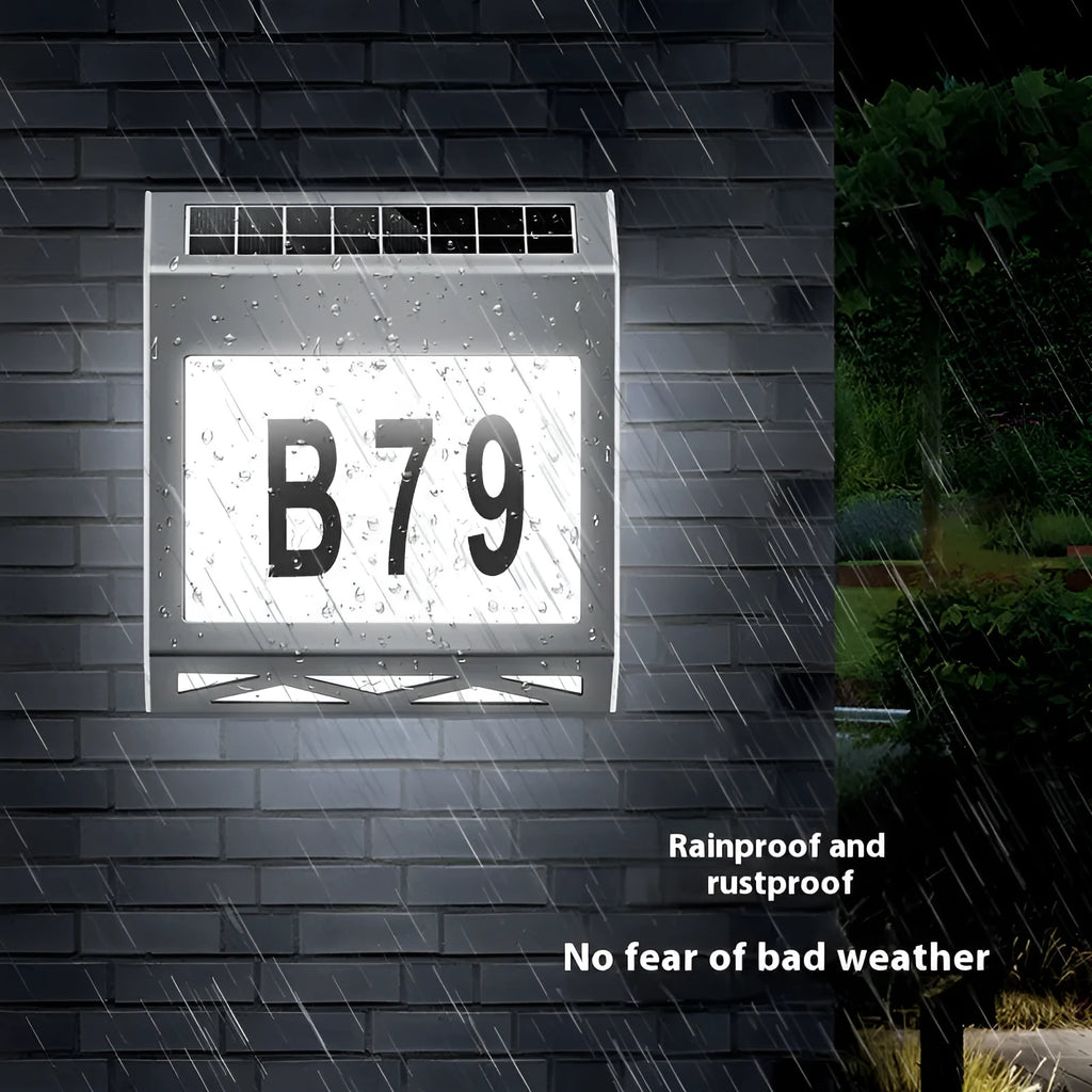 Solar powered waterproof doorplate light with LED illumination in black or silver finish