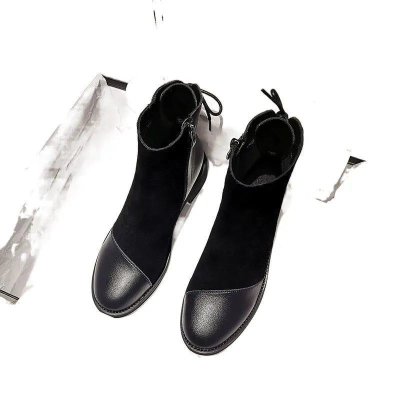 Black women's knee-high Martin boots with side zip and a decorative bow.