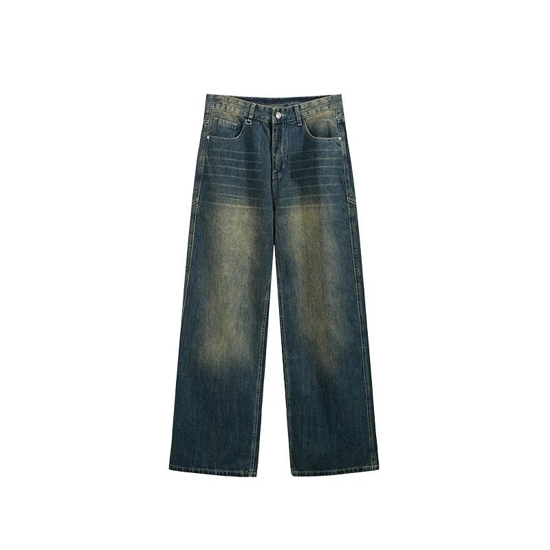 Man wearing washed blue wide leg straight-cut jeans with a mid waist and zipper fly.