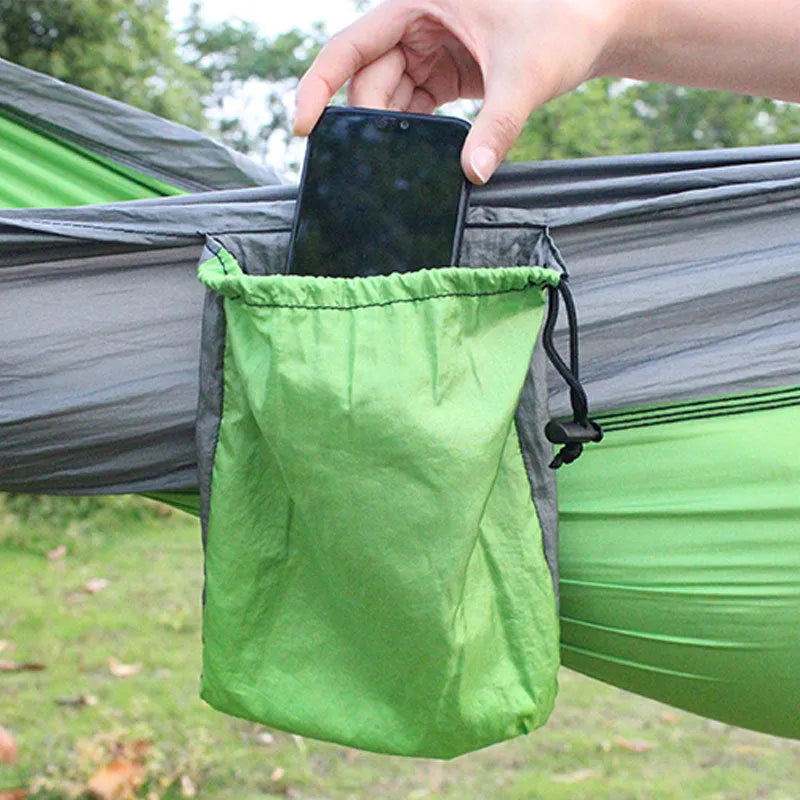 Sapphire blue parachute nylon hammock hung between trees, showing its full 270cm length and woven texture.