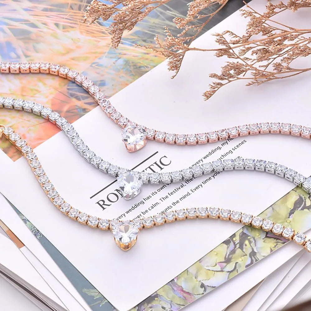Gold heart-shaped rhinestone collar for dogs and cats on a white background.
