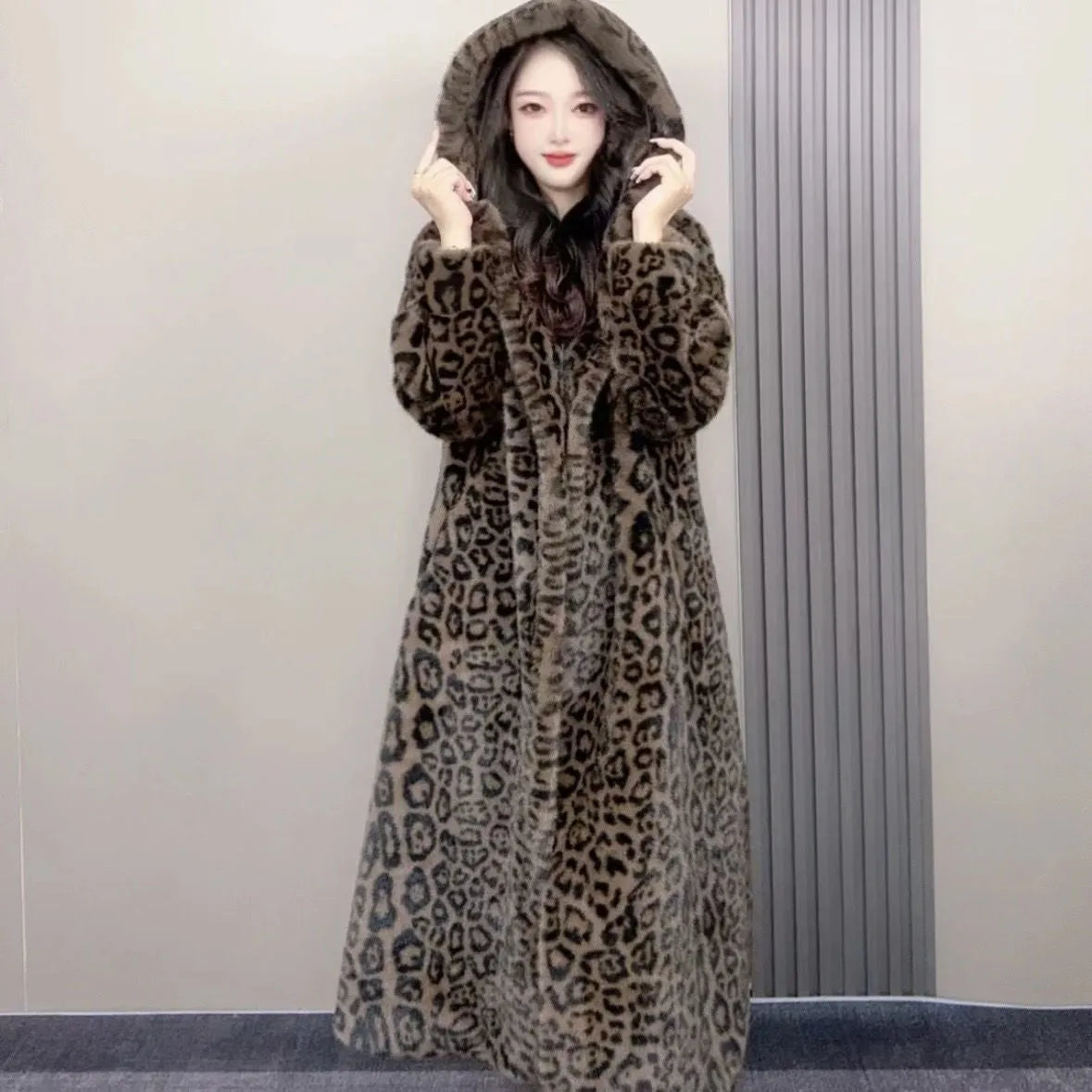 Long brown leopard print faux fur coat on a plus-size model, showing its 100cm length and loose fit.