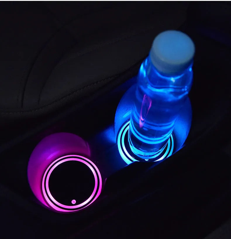 Colourful LED light-up coaster for car cup holder, showing multiple LED colours on a black acrylic base.