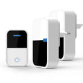 Modern white wireless doorbell kit with plug-in receiver and self-powered push button on a wooden door frame.